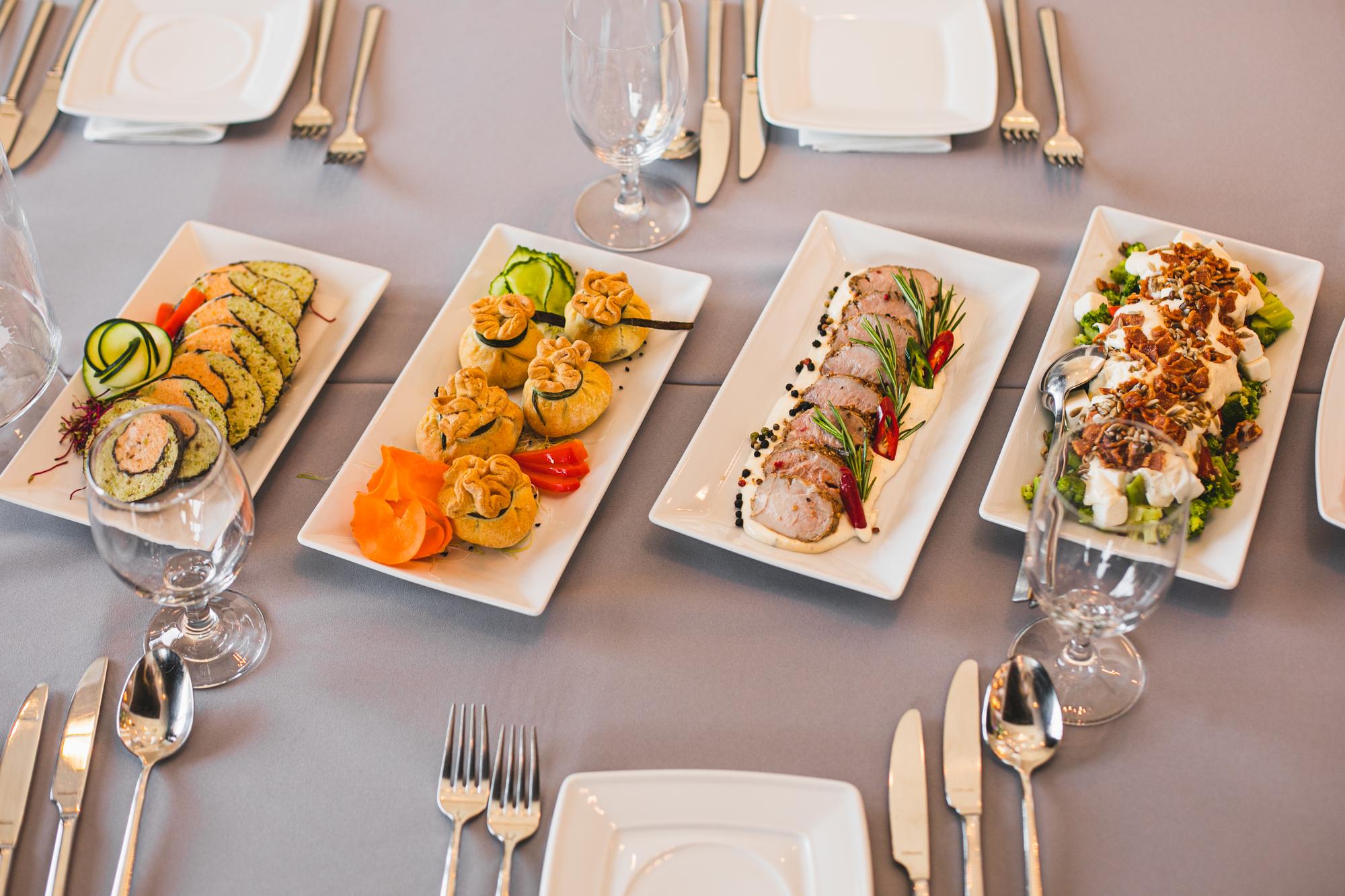 Assorted plated dishes laid out on table